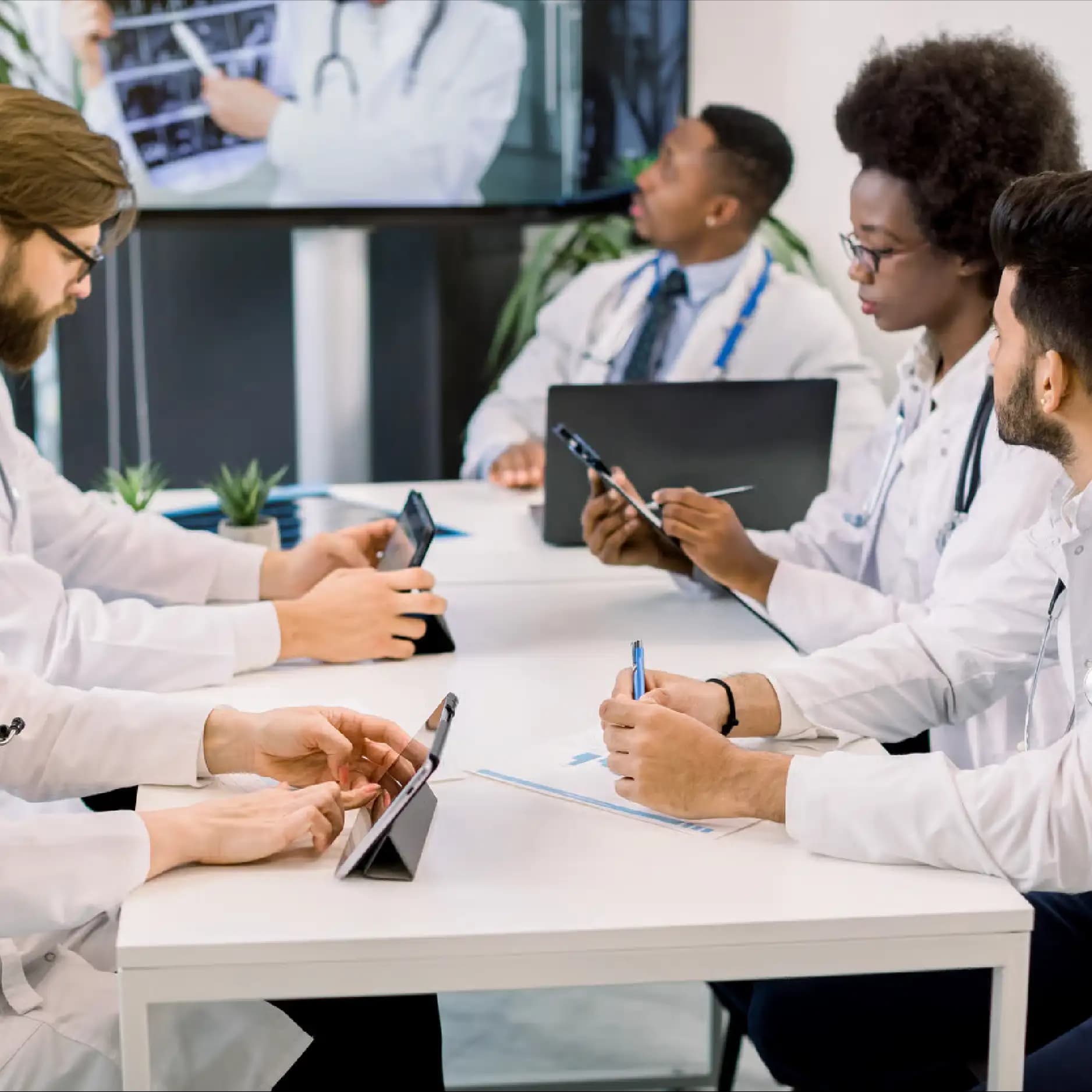 Clinicians reviewing case material together around a meeting table